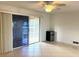 Living room with tile floors, sliding doors, and ceiling fan at 3751 S School Ave # 29, Sarasota, FL 34239