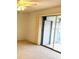 Bright bedroom with carpet flooring and sliding glass door to balcony at 3751 S School Ave # 29, Sarasota, FL 34239