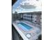 Community pool and surrounding building view from balcony at 3751 S School Ave # 29, Sarasota, FL 34239