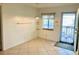 Small dining area with tile floors and access to a balcony at 3751 S School Ave # 29, Sarasota, FL 34239