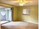 Bright bedroom with ceiling fan and sliding glass doors at 3751 S School Ave # 29, Sarasota, FL 34239