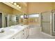 Bathroom with double vanity, soaking tub, and shower at 5370 Hyland Hills Ave # 2721, Sarasota, FL 34241