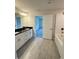 Bathroom featuring double vanity, tub, and light gray tile floors at 5605 Gaffney Avenue, North Port, FL 34291