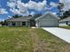 Charming one-story home with a well-manicured lawn, attached garage, and lovely neutral-tone paint at 5605 Gaffney Avenue, North Port, FL 34291