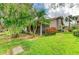 Home exterior showcasing a screened patio and beautifully landscaped yard at 5669 Pipers Waite # 38, Sarasota, FL 34235