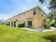 Spacious backyard featuring a lawn, patio, and a well-maintained exterior of a townhome at 6205 Triple Tail Ct # 101, Lakewood Ranch, FL 34202