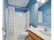Bathroom with blue walls, shower/tub, single sink vanity, and tile floors at 6205 Triple Tail Ct # 101, Lakewood Ranch, FL 34202