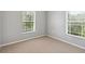 Bedroom with carpet, and bright natural light from the two windows at 6205 Triple Tail Ct # 101, Lakewood Ranch, FL 34202
