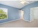 Bedroom features a ceiling fan and includes access to a closet and doorway at 6205 Triple Tail Ct # 101, Lakewood Ranch, FL 34202