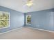 Bedroom with blue walls, carpet, ceiling fan, and two windows at 6205 Triple Tail Ct # 101, Lakewood Ranch, FL 34202