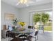 Bright dining area features a glass table, wood chairs, and view of the water at 6205 Triple Tail Ct # 101, Lakewood Ranch, FL 34202