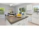 Modern kitchen with island and dining area overlooking the yard at 6205 Triple Tail Ct # 101, Lakewood Ranch, FL 34202
