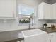 Bright kitchen featuring a stainless steel faucet and apron-front sink at 6205 Triple Tail Ct # 101, Lakewood Ranch, FL 34202