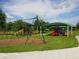 Community playground featuring swings, slides, and shaded structures, perfect for outdoor fun at 6205 Triple Tail Ct # 101, Lakewood Ranch, FL 34202