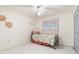 Small bedroom with a twin bed, tile floor, and window coverings at 6352 Coniston Ter, North Port, FL 34287