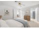 Comfortable bedroom with neutral tones, tiled floors, closet, and en suite bathroom at 6352 Coniston Ter, North Port, FL 34287