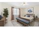Bright bedroom with a ceiling fan, a queen bed and a cozy sitting bench at 6352 Coniston Ter, North Port, FL 34287