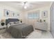 Cozy bedroom with cool-toned bedding, coordinating artwork, and soft, natural lighting at 6352 Coniston Ter, North Port, FL 34287
