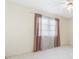 Bedroom featuring neutral colors, window with curtains, and white tile flooring at 6352 Coniston Ter, North Port, FL 34287