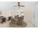 Well-lit dining area featuring a modern ceiling fan and comfortable seating at 6352 Coniston Ter, North Port, FL 34287
