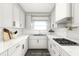 Contemporary kitchen featuring new white cabinets, stainless steel appliances, and subway tile backsplash at 6352 Coniston Ter, North Port, FL 34287