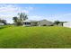 Large backyard with screened porch and lush grass at 6352 Coniston Ter, North Port, FL 34287