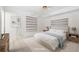 Serene main bedroom with neutral colors, tile floors, and ample natural light at 6352 Coniston Ter, North Port, FL 34287