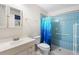 Bathroom with shower, tile flooring and a blue shower curtain at 6352 Coniston Ter, North Port, FL 34287