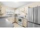 Kitchen features stainless steel appliances and white cabinets at 6352 Coniston Ter, North Port, FL 34287