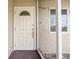 Front entrance with decorative glass and landscaping at 6352 Coniston Ter, North Port, FL 34287