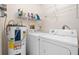 Laundry room with washer, dryer, and extra shelving at 6352 Coniston Ter, North Port, FL 34287