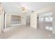 Open living room with tile floors and access to other rooms at 6352 Coniston Ter, North Port, FL 34287