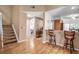 Light-filled hallway with wood floors and staircase at 6581 Approach Rd # 63, Sarasota, FL 34238