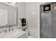 Clean bathroom with marble vanity, and a shower with glass enclosure at 75 Osprey Point Dr, Osprey, FL 34229