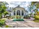 Charming patio with seating area and lush landscaping at 75 Osprey Point Dr, Osprey, FL 34229