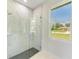 Large walk-in shower with marble tile and glass enclosure at 7648 Totem Ave, North Port, FL 34291