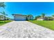 Single-Gathering home with gray exterior, paved driveway, and landscaping at 7648 Totem Ave, North Port, FL 34291