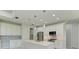 Modern kitchen with white cabinets, quartz countertops, and stainless steel appliances at 7648 Totem Ave, North Port, FL 34291