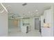 Modern kitchen features white cabinets, an island, and stainless steel appliances at 7648 Totem Ave, North Port, FL 34291