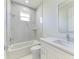 Clean bathroom with white cabinets, marble shower, and bathtub at 7648 Totem Ave, North Port, FL 34291