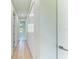 Long hallway with light walls and wood-look floors at 7648 Totem Ave, North Port, FL 34291