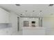 Modern kitchen with white cabinets, quartz countertops, and island at 7648 Totem Ave, North Port, FL 34291