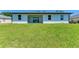 Spacious backyard with a large grassy area and a patio at 7648 Totem Ave, North Port, FL 34291