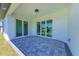 Covered patio with paver stones and sliding glass doors at 7648 Totem Ave, North Port, FL 34291