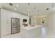 Modern kitchen with white cabinets, stainless steel appliances and island at 7648 Totem Ave, North Port, FL 34291