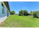 Large backyard with green grass and a privacy fence at 7648 Totem Ave, North Port, FL 34291