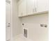 Laundry room with white cabinets and built-in shelving at 7648 Totem Ave, North Port, FL 34291