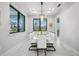 Elegant dining room with a modern chandelier, a table set for a meal, and large windows at 109 Marker Rd, Rotonda West, FL 33947
