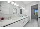 Double vanity bathroom with white marble countertop and modern lighting at 109 Marker Rd, Rotonda West, FL 33947