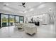 Spacious open-concept living area with a modern kitchen, marble floors, and a view of the backyard at 109 Marker Rd, Rotonda West, FL 33947